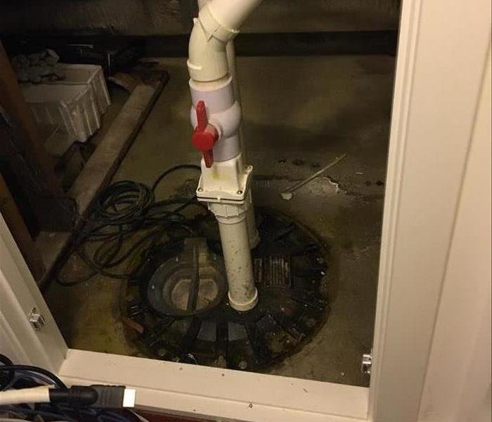 photo of a sump pump in a basement