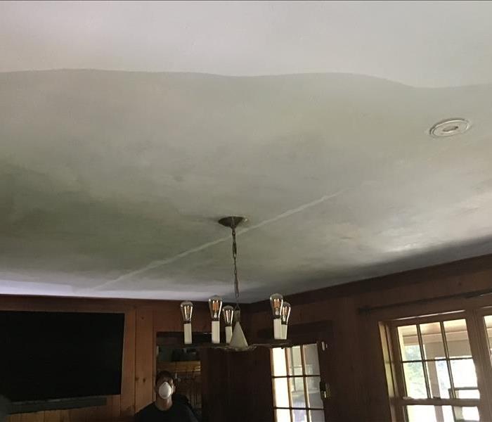 photo of large water stain on ceiling from ice dam causing roof to leak