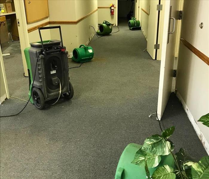 photo of drying equipment in an office that flooded due to a burst pipe