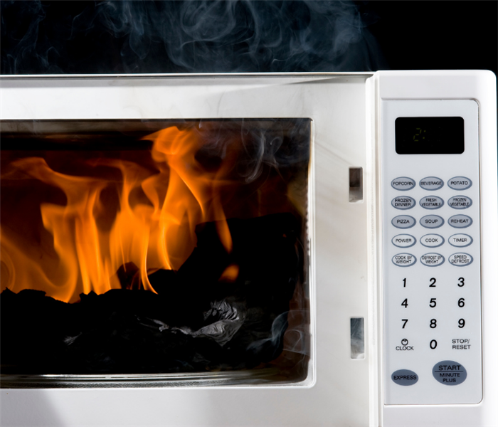 photo of microwave smoking with a fire inside it